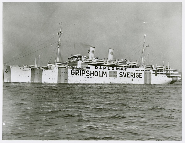 The Swedish liner Gripsholm at sea, with DIPLOMAT, GRIPSHOLM and SVERIGE painted in large letters on her hull.